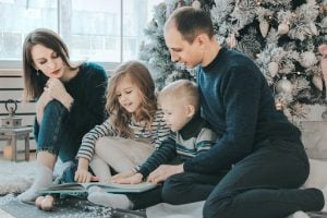 family reading stories under the christmas tree in their luxury house and lot in brittany santa rosa | Luxury homes by brittany corporation