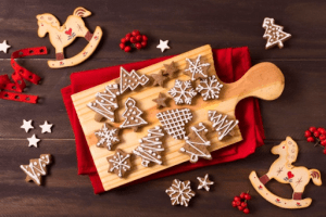 gingerbread cookies spread out on a chopping board on red cloth on a brown table | luxury homes by brittany corporation