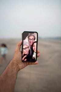 hand doing a facetime with his family | Luxury Homes by Brittany Coporation