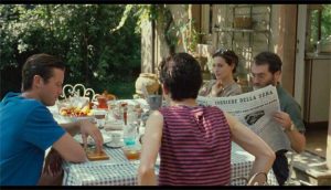 oliver elio perlman and mother corriere della sera reading scene blue table cloth and grass outdoor luxury properties | Luxury Homes by Brittany Corporation
