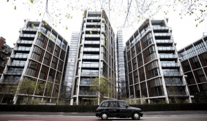 one hyde park london luxury condominium low rise luxury condo building with black car in front and trees | Luxury Homes by Brittany Corporation