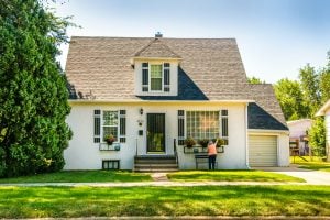 Photo of a huge wooden house surrounded by greeneries. | Luxury homes by brittany corporation