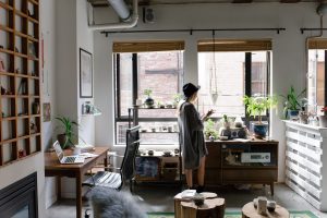 Photo of a woman standing near the window | luxury homes by brittany corporation