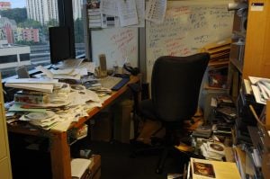 Photo of an office table with pile of papers | luxury homes by brittany corporation