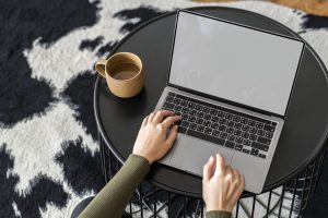 Woman working from home on a laptop with empty screen | luxury homes by brittany corporation