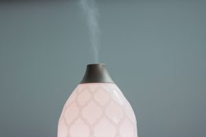 White and black diffuser photo with vapor coming out on the valve | luxury homes by brittany corporation