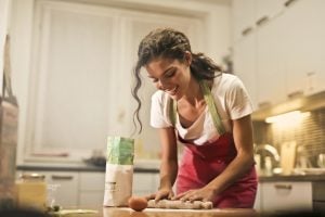 Woman happily baking. | luxury homes by brittany corporation