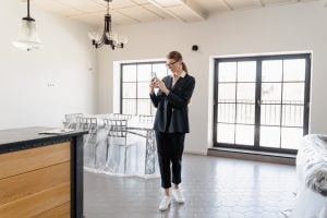 Woman taking picture inside a home | Luxury homes by brittany corporation