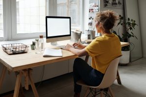 Woman working on an organized workstation. | luxury homes by brittany corporation