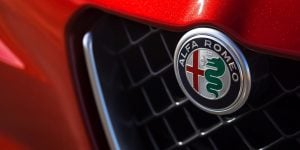 alfa-romeo-giulia-logo blue circle with green snake and red cross | luxury homes by brittany corporation