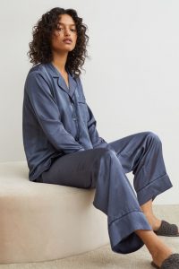 blue satin pajama set on dark skinned lady with fluffy slippers | luxury homes by brittany corporation