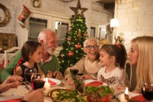 Happy family at Christmas dinner party | luxury homes by brittany corporation