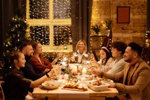 family having christmas dinner in luxury home | luxury homes by brittany corporation