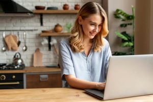 front-view-beautiful-woman-with-laptop | luxury homes by brittany corporation