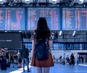 lady waiting in an airport | luxury homes by brittany corporation