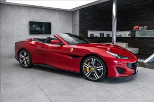 luxury car iconic italian car rosso portofino red in a car show | luxury homes by brittany corporation