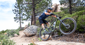 man riding a mountain bike in an off-road trail | luxury homes by brittany corporation