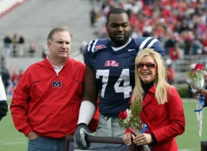 nfl player with his adoptive parents | luxury homes by brittany corporation