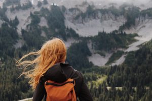 photo of lady in front of a mountain | luxury homes by brittany corporation