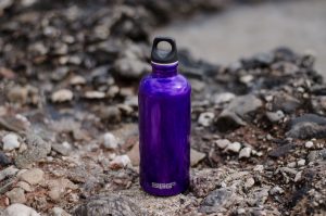 purple water bottle on the side of the off-road biking trail | luxury homes by brittany corporation