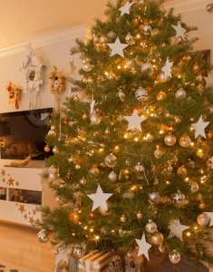 starry night holiday tree in a spacious living room in luxury homes | luxury homes by brittany corporation