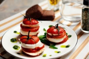 tomato caprese tower salad roast tomatos with ricotta and basil puree | luxury homes by brittany corporation