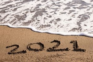 2021 written on the sand in a beach | luxury homes by brittany corporation