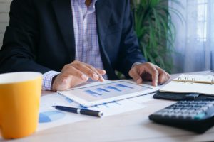 Image of a man browsing through a chart. | luxury homes by brittany corporation