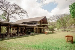 brown building in the middle of a field of grass | luxury homes by brittany corporation