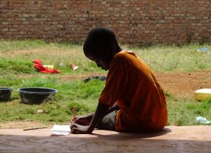 child writing on the floor | luxury homes by brittany corporation