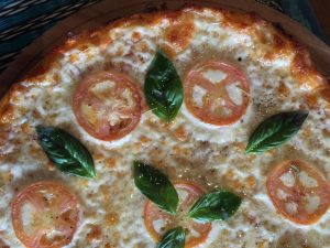 close up of margherita pizza | luxury homes by brittany corporation