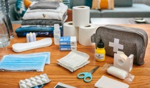 Emergency backpack equipment with first aid kit organized on the table | luxury homes by brittany corporation