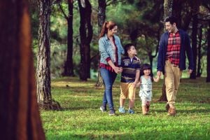 family in a pine tree forest | luxury homes by brittany corporation