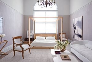 large room with white walls and a four post bed | luxury homes by brittany corporation
