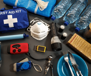 must-have items in the pandemic blue first aid kit water flashlight | luxury homes by brittany corporation