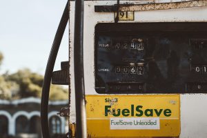 old fuel save bus getting gas in a gasoline station | luxury homes by brittany corporation