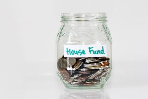 a glass of coins for house funds | luxury homes by brittany corporation