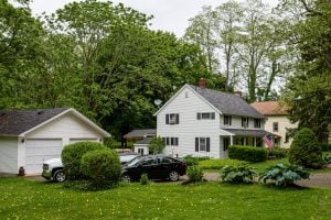 typical American residential house building with American flag a | luxury homes by brittany corporation