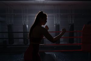 woman doing shadow boxing in the dark | luxury homes by brittany corporation
