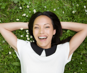 woman relaxing while smiling toward the camera | luxury homes by brittany corporation