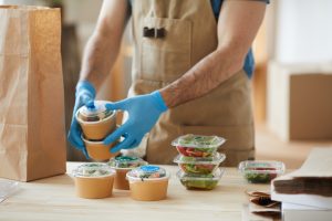 Worker Wearing Gloves at Food Delivery Service | luxury homes by brittany corporation