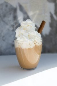 Photo of a chocolatey drink in a glass topped with whipped cream. | luxury homes by brittany corporation