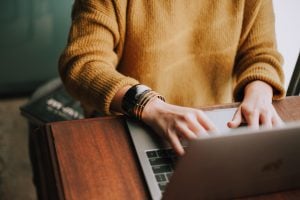 Photo of a person using a laptop. | luxury homes by brittany corporation