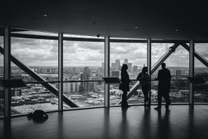 Photo of people standing inside a city building. | luxury homes by brittany corporation
