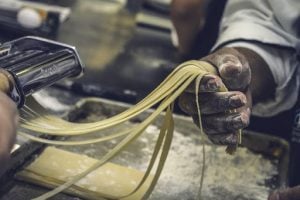 person making pasta from dough | luxury homes by brittany corporation