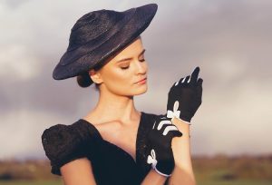 woman wearing black with a hat lace and gloces | luxury homes by brittany corporation