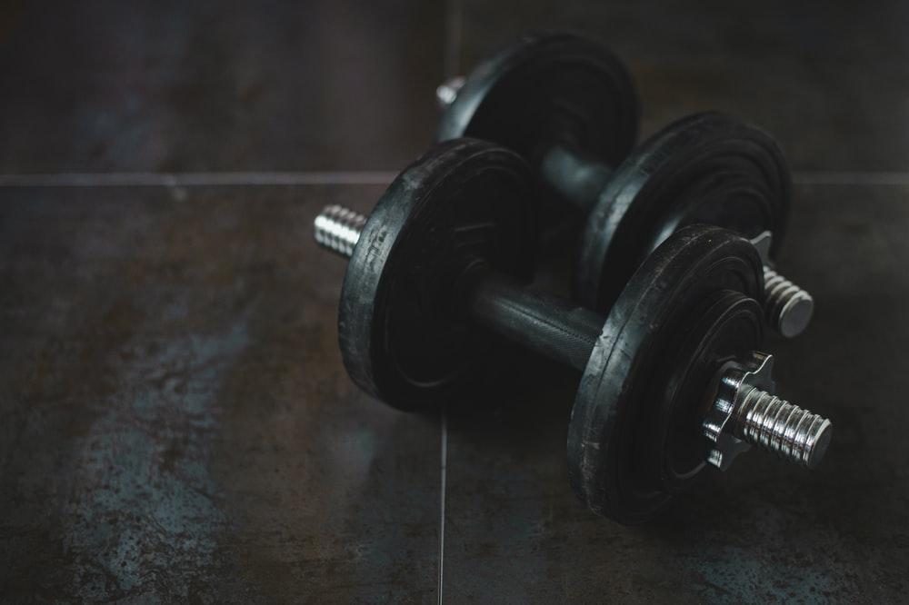 Add or remove weight as needed with these adjustable dumbbells. Photo from Unsplash.