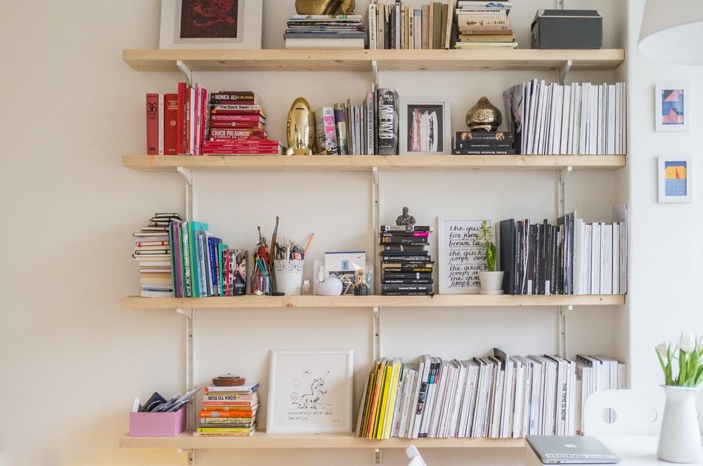 Floating shelves can make a small home library possible in a luxury condo. Photo from Unsplash.