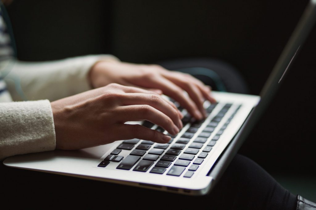 Photo of a person's hand typing over the laptop keyboard. - 5 Easy Steps to Creating Winning Sales Presentations