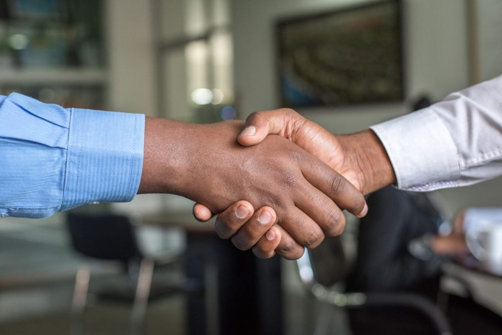 Photo of two hands shaking each other - prices increases